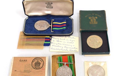 A cased Civil Defence Long Service Medal together with a...