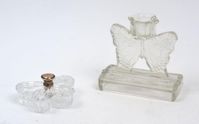 A clear polished glass candlestick, 20th century, modelled in the shape of a butterfly atop a stepped base, 11cm high, together with a glass butterfly shaped lidded dish with white metal finial, 6cm x 8.5cm x 4.5cm (2)