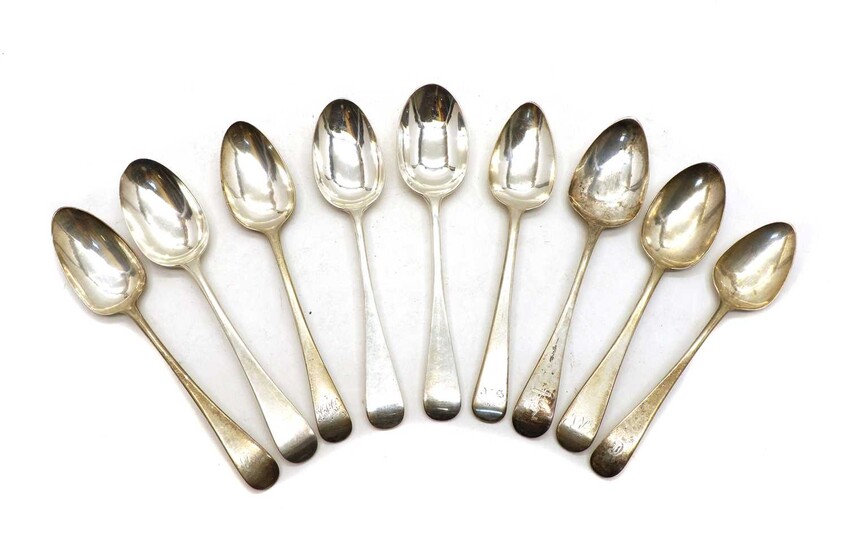 A collection of five George III Old English pattern silver dessert spoons