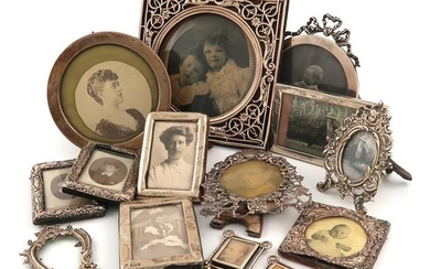 A collection of fourteen silver photograph frames, comprising:...