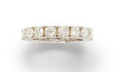 A diamond and fourteen karat white gold band ring