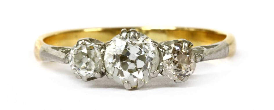 A gold and platinum three stone diamond ring