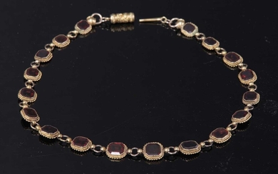 A gold garnet set rivière necklace