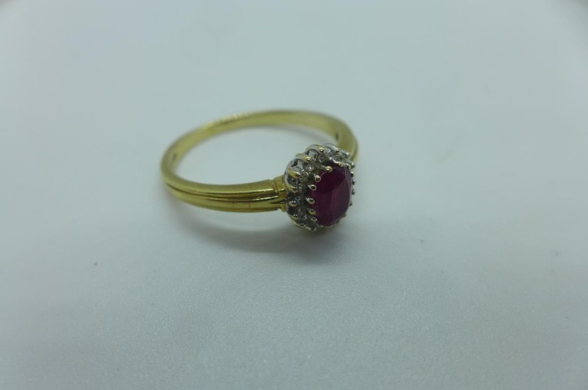 A hallmarked 9ct yellow gold ruby and white stone ring, size...