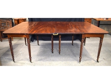 A large antique mahogany two section dining table with two f...