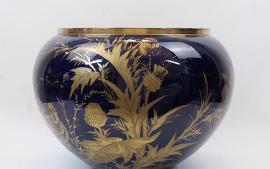 A large ceramic cobalt blue jardiniere, 20th century, the exterior gilt-heightened with two partridges and various flora, inscribed K. G. Luneville to the underside, 38cm high, 40cm diameter at rim