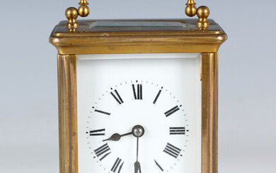 A late 19th century French lacquered brass carriage timepiece, the enamelled dial with Roman hour nu