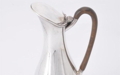 A late Victorian silver elongated baluster hot water jug by Joseph Rogers and Sons