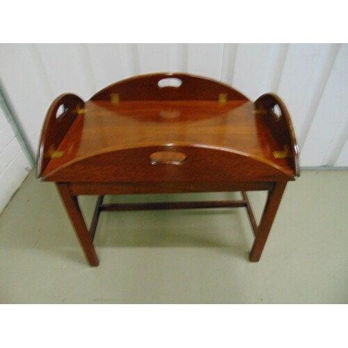 A mahogany butlers tray and stand of customary form with ins...