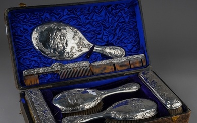 A matched Edwardian silver mounted dressing table service to...