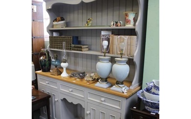 A modern pine and grey painted kitchen dresser with three in...