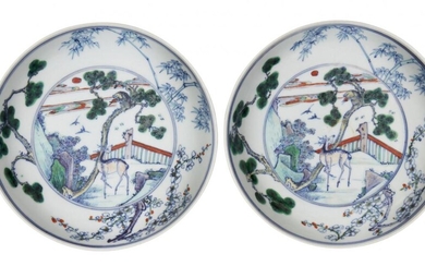 A pair of Chinese doucai porcelain dishes, 18th century, each painted to the interior with a central medallion depicting a deer below a monkey on a pine tree, surrounded by bees and a pair of magpies in flight, all encircled by the 'three friends...