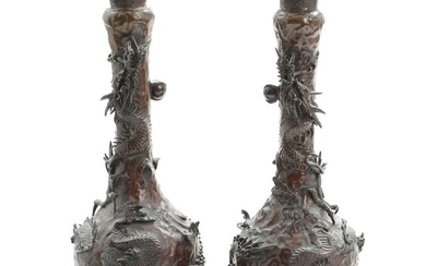 SOLD. A pair of Japanese patinated bronze vases, cast with dragons chasing the burning pearl...