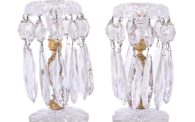 A pair of cut and moulded clear glass and gilt metal mounted lustre candlesticks