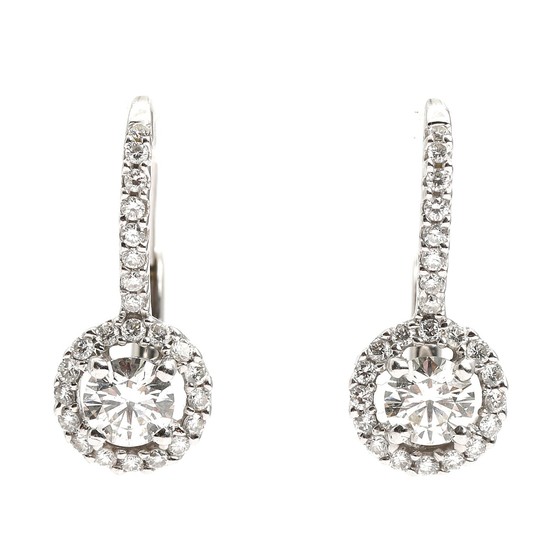 A pair of diamond ear pendants each set with a brilliant-cut diamond encircled by numerous brilliant-cut diamonds, mounted in 18k white gold. L. 1.7 cm. (2)