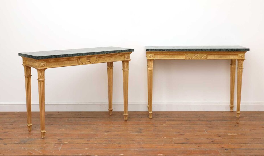 A pair of giltwood console tables in the manner of Robert Adam