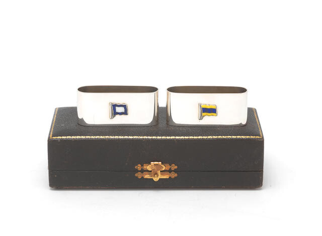 A pair of silver and enamel signal flag napkin rings