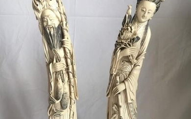 A pair of statuettes in ivory, a man...
