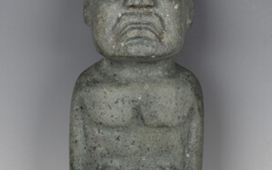 A pre-Columbian Olmec style carved green hardstone standing male figure, probably 900-450 BC, bearin