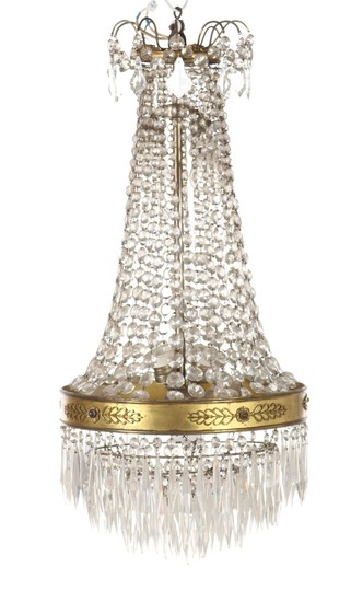 A prism chandelier with partly gilt bronze frame, inside six sockets. Circa 1900. H. 88. Diam. 40 cm.