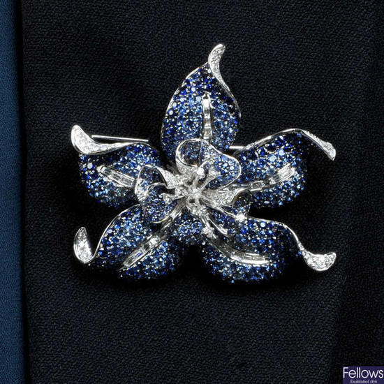 A sapphire and diamond flower brooch.May be worn as a