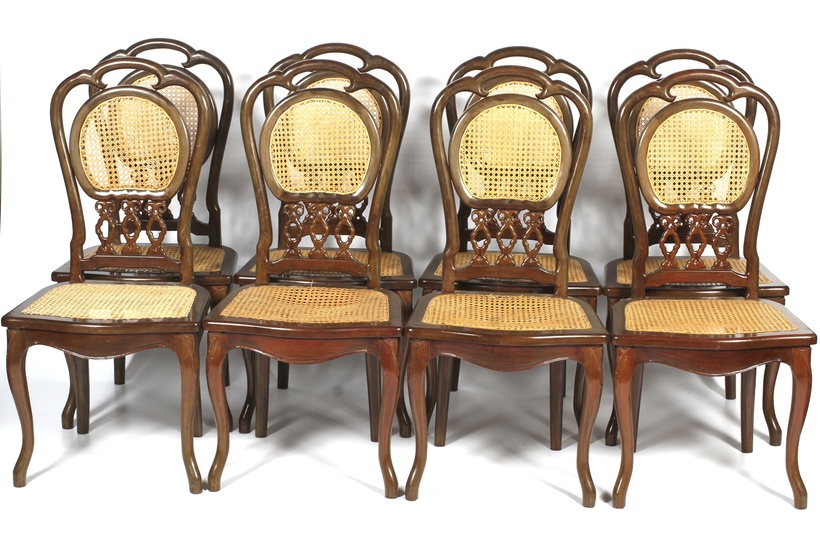 A set of eight contemporary caned dinning chairs. Each with pierced foliate shaped caned back, with caned seat, on cabriole shaped legs to front, 110cm high