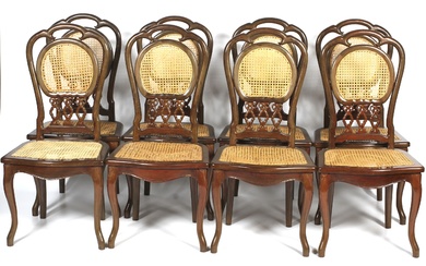A set of eight contemporary caned dinning chairs. Each with pierced foliate shaped caned back, with caned seat, on cabriole shaped legs to front, 110cm high