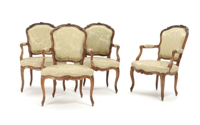 A set of four French Louis XV beech armchairs, carved with flowers and foliage, cabriole legs. 18th century. (4)