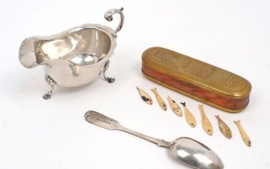 A silver sauce boat by Harrods, London, 1938, designed with shell shoulders and pad feet, together with a Victorian silver dessert spoon and a copper and brass Dutch tobacco box containing several bone playing counters designed as fish, weighable...
