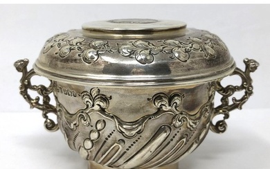 A silver two handled cup and cover, the cover inset with an ...