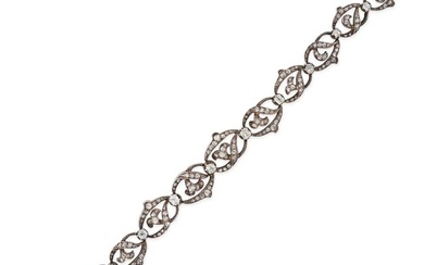 AN ANTIQUE FRENCH DIAMOND BRACELET in 18ct yellow gold and silver, comprising a row of scrolling ...