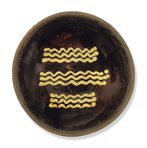 AN ENGLISH EARTHENWARE SLIPWARE BAKING OR LOAF-DISH, EARLY 19TH CENTURY, INCISED 24 TO THE REVERSE