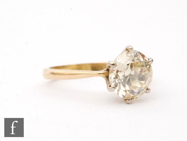 An 18ct hallmarked diamond solitaire ring, claw high set old...