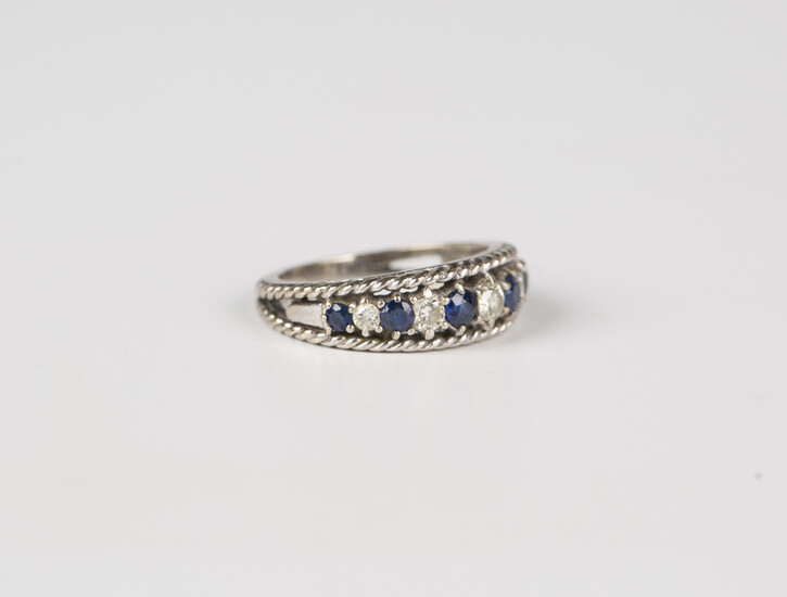An 18ct white gold, sapphire and diamond eleven stone half-hoop ring, mounted with six circular cut