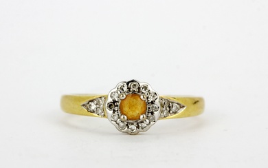 An 18ct yellow and white gold ring set with a citrine and diamonds, (O.5).