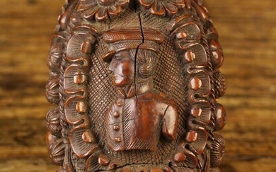 An 18th Century Carved Coquilla Nut. The egg-shaped nut elaborately carved with three portrait busts