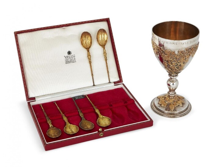An Apsrey & Co. silver goblet with gilt fruiting vine overlay, London, c.1972, designed with knopped stem and gilt decoration to body and stepped foot, the rim with personalised engraving, together with a cased set of six silver gilt replica...