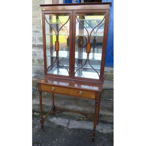 An Edwardian mahogany cabinet on stand, the upper section ha...