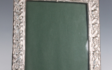 An Elizabeth II silver mounted rectangular photograph frame with arched top, embossed with flowers