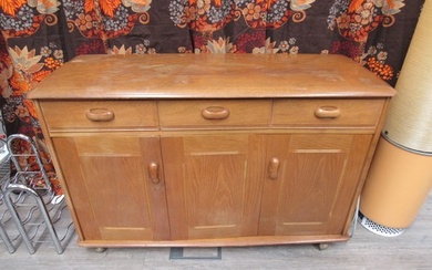 An Ercol small side cabinet with three cupboard doors and th...
