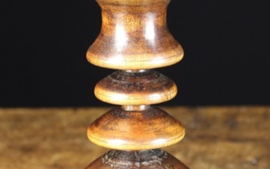 An Unusual Turned Treen Candlestick of good colour & patination. The cavetto moulded socket above a