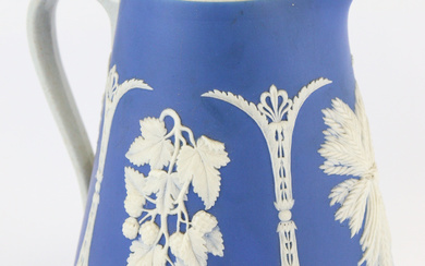 An antique jasper ware white on blue pitcher, marked to...
