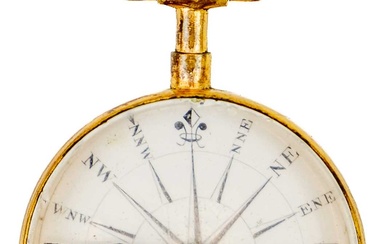 An early 19th century gilt brass compass with enamel dial and blue steel needle.