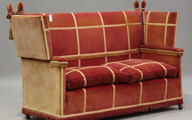 An early 20th century Knole settee, upholstered in pink velour with gilt braid borders, height 118cm