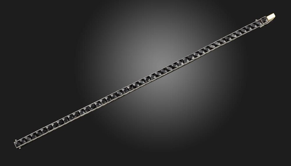 An early 20th century black onyx line bracelet, the calibre-cut...