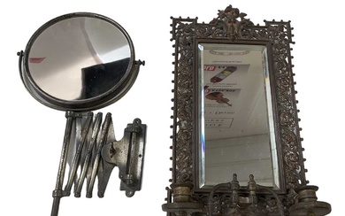 An elaborately gilt framed brass wall mirror with pair of...