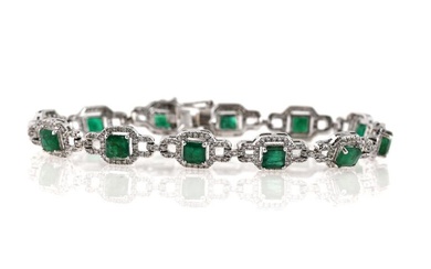 An emerald bracelet set with twelve faceted emeralds weighing a total of...