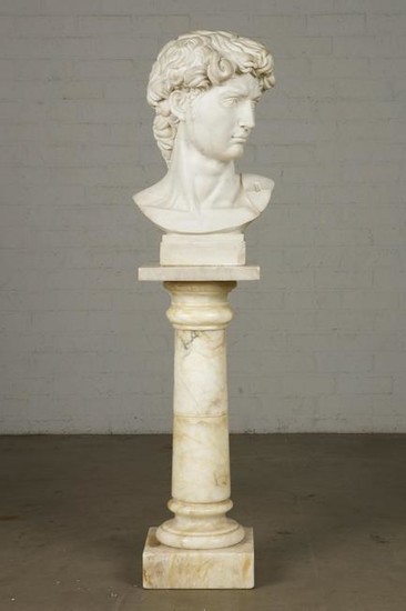 An marble bust of a young man on pedestal
