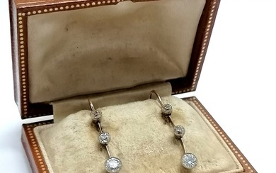Antique pair of unmarked gold triple diamond drop earrings (...