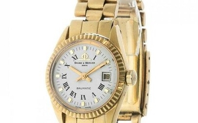 BAUME MERCIER ladies watch. 80`'S In yellow gold. White dial with black Roman numerals. Baton hands.